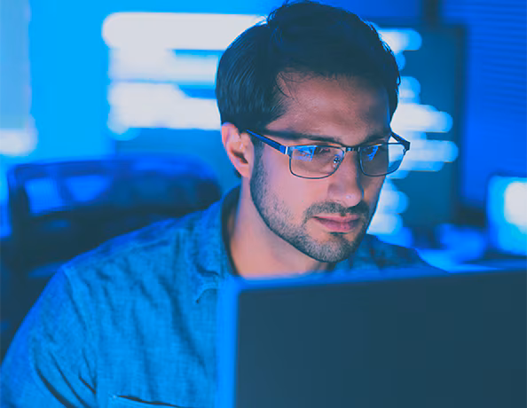 man looking at monitor screen